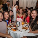 studnets pose at a table during the Eyeball 2016 party