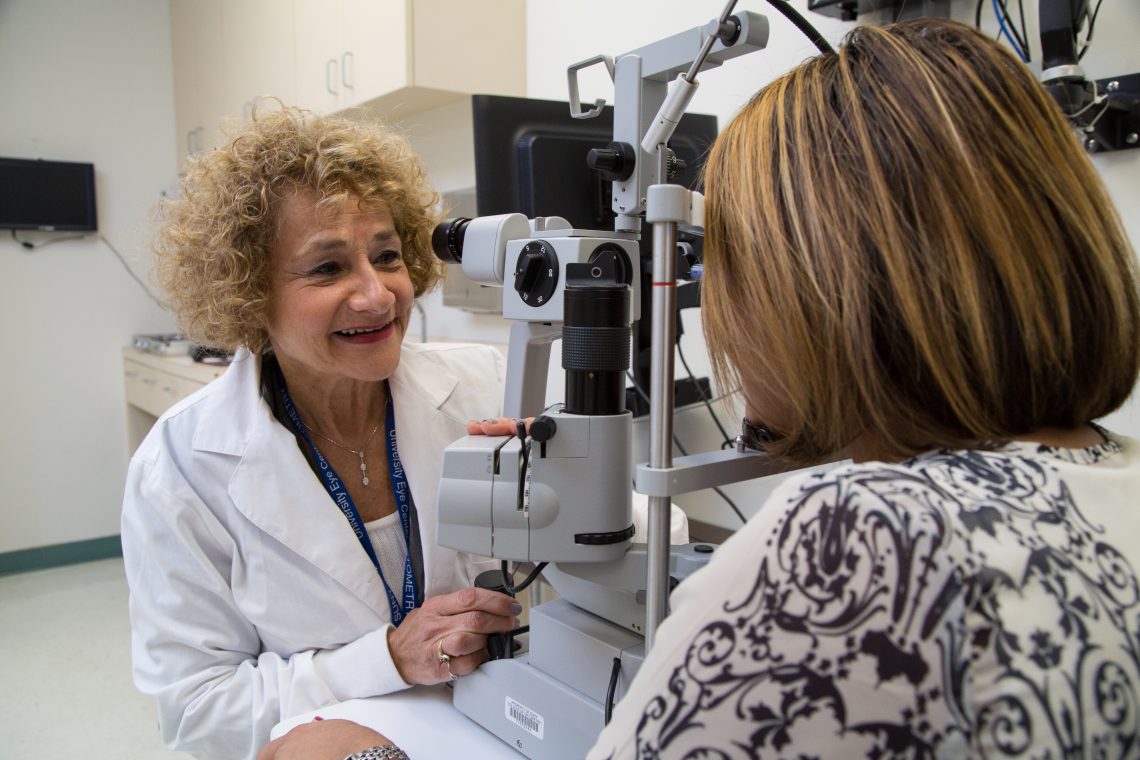 Doctor smiling with patient at eye exam