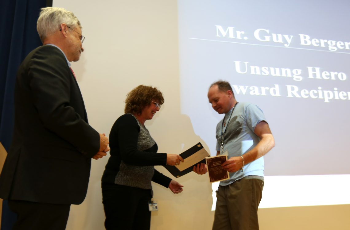 Staff receiving award in theater