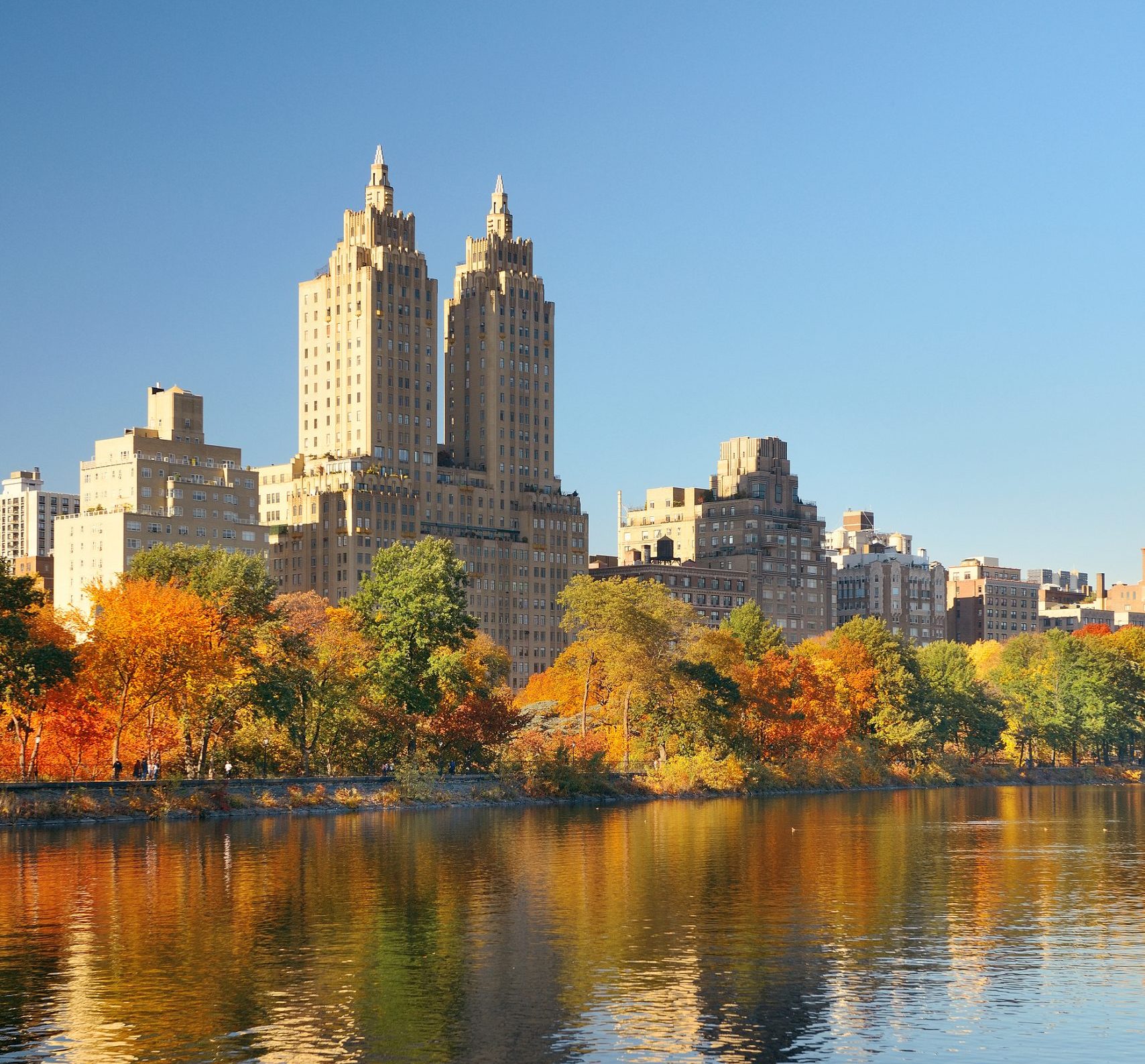 Skyline with apartment skyscrapers over lake in Central Park in