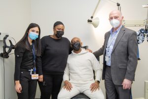  Drs. Melissa Levine and David Libassi share a joyful moment with Melissa Benjamin and her fiancé/UEC patient Kasson Woods after receiving a custom prosthetic eye.