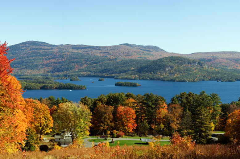 a lake surrounded by trees and mountains