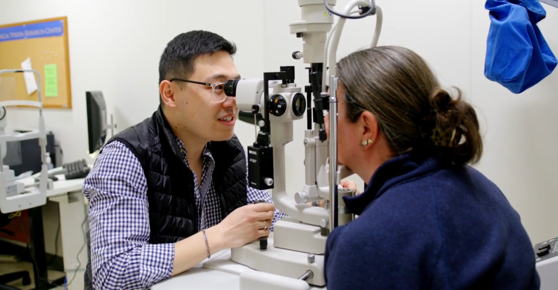 Dr Jerry Li using optometry equipment to look into unidentified person's eye