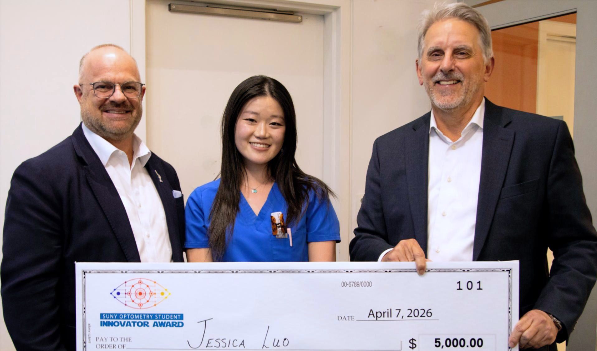 Group of three holding a $5,000 check