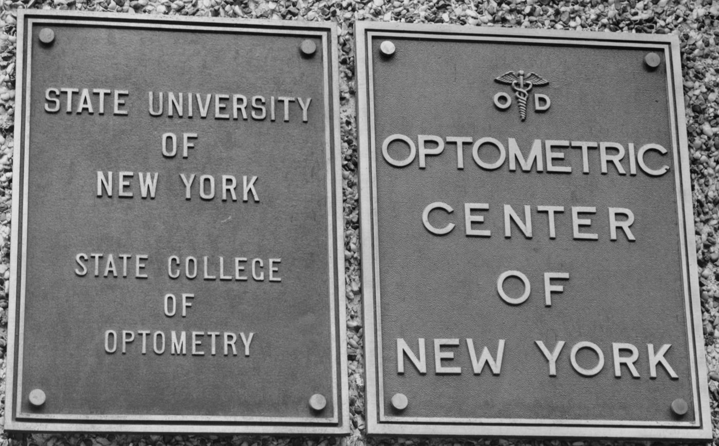 Two silver placades which say SUNY Optometry on one and Optometric Center of New York on the other