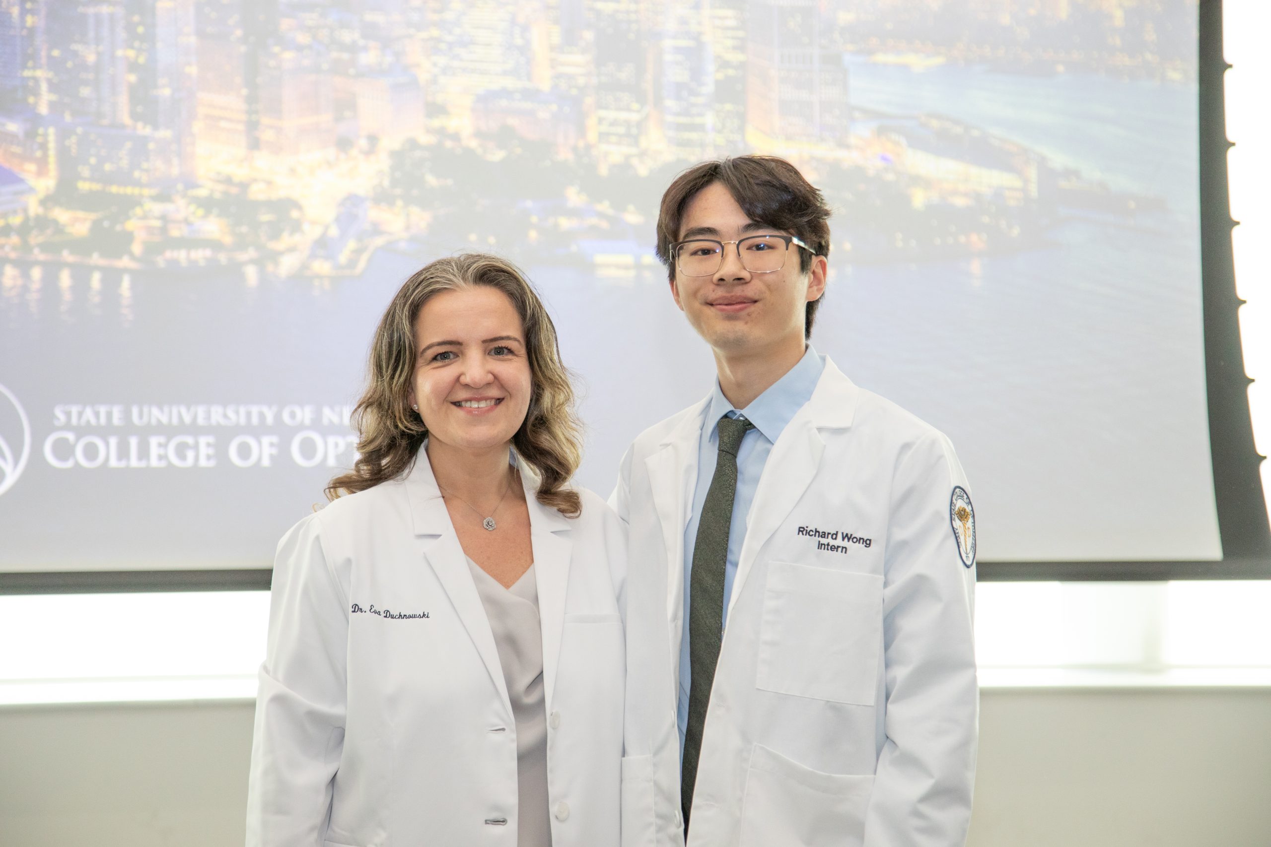 A man and women in white optometry coats
